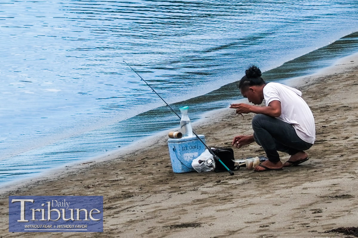 Men are seen catching fish in Mabua Beach in Tandag City, Surigao del Sur on 17 June 2024.